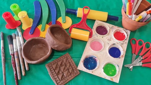 Clay model of a pot and tile with paint and craft materials